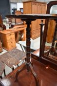 A traditional oak pedestal wine table, diameter approx 30cm, some repair and warping