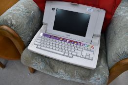 A vintage electronic typewriter, Brother Lw-840ic, with carry bag etc