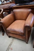A modern brown leather tub chair