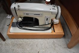 A vintage sewing machine in case, Merritt