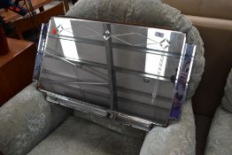 A vintage geometric frameless wall mirror, in the 1930s style