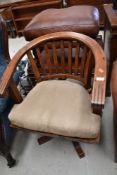 A hardwood swivel chair with suede style cushion