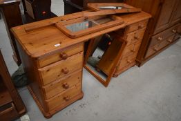 A modern pine twin pedestal dressing table having triptych mirror back, approx. width 138cm, would