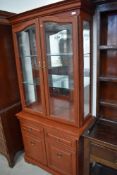 A good quality modern display cabinet with double drawers and cupboard under, illuminating top