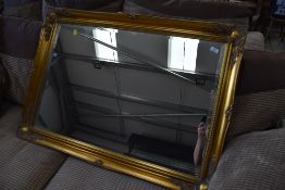 A large gilt frame over mantel style wall mirror, approx. 106 x 75cm