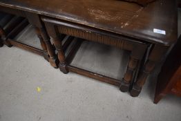 A vintage Ercol style dark stained coffee table with nest of two occasional tables, width approx.