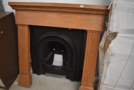 A reproduction cast fire place,and wooden surround