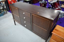 A vintage mahogany effect sideboard, having central set of 4 drawers flanked by cupboard