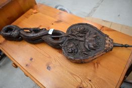 A set of carved bellows, having serpent handles