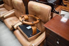 Two tan leather stressless armchairs and a footstool