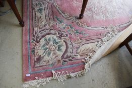 A large Chinese carpet square having pink ground , approx 300 x 214cm