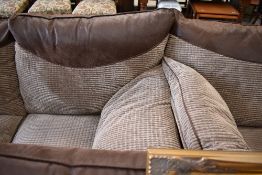 A modern part leather lounge suite comprising two settees, armchair and footstool