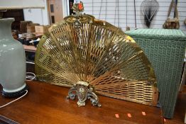 A vintage brass firescreen of fan form , having 9 sections