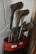 A selection of vintage golf clubs in bag