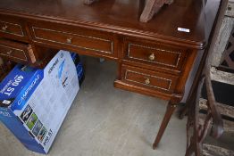 An early to mid 20th Century mahogany dressing table in the classical style with gilt metal mirror