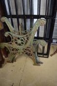 A pair of cast bench ends, coalbrookdale stle with rosette and urn decoration