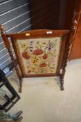 An early 20th Century oak fire screen