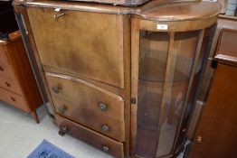 A mid 20th Century walnut display, having central bureau or cocktail section, width approx. 120cm