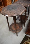An Arts & Crafts plant stand/occasional table, octagonal form, heavily carved holly and berry