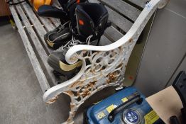 A traditional garden bench, having cast ends , Coalbrookdale style with lion mask, vase and swag