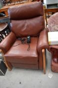 A modern leather and wood frame electric recliner chair