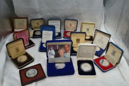 A collection of Fourteen Silver World Crown Sized Coins in cases