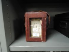 A brass cased carriage clock possibly late 19th century having leather case and enamel face dial
