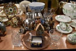 A mixed lot containing glass ware, stainless steel, cufflinks and a copper charger, wooden figurines