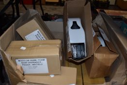 A box full of unused commerical soap despensers.