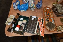 A selection of vintage gents toiletry sets, including shaving brushes, razor and manicure sets and a