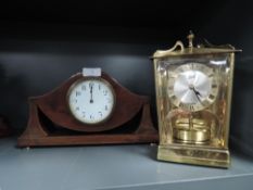 An early 20th century mantle clock being Swiss made signed Burnem having mahogany case also