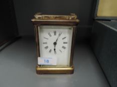 A brass cased French carriage clock having enamel face plate
