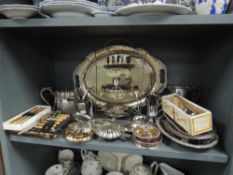 An impressive selection of silver plated items including cake stand, tea set, and cutlery
