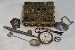 A small white metal box having filligree and agate decoration containing a small selection of HM