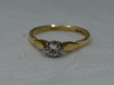A lady's diamond solitaire dress ring, approx 0.25ct in a claw set raised mount to shaped