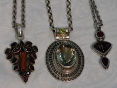 Three silver pendants of Artisan style having garnet, coral and green/red paste stone decoration