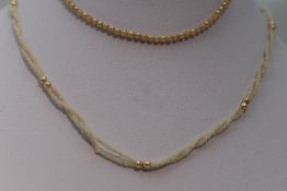 A twisted double string of seed pearls and a child's string of seed pearls