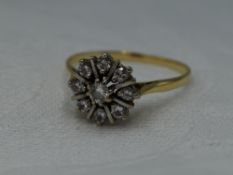 A lady's dress ring having a diamond star burst cluster, approx 0.5ct on a yellow metal loop, no