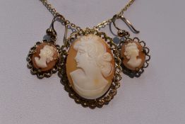 A conche shell cameo brooch/pendant depicting a maiden in profile in a decorative 9ct gold mount