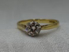 A lady's diamond solitaire dress ring, approx 0.75ct in a claw set mount to raised shoulders on an