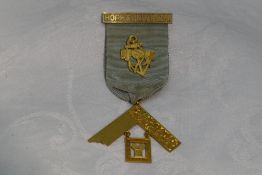 A Masonic jewel stamped 9ct regarding the Hope & Unity Lodge no: 214, awarded to W Bro W J