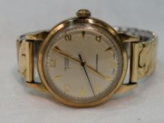 A gents 1960's 9ct gold wrist by J W Benson of London having Arabic numeral and baton dial with