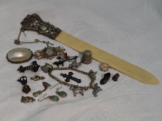 A small selection of HM silver and white metal including a thimble, page turner, loose charms,