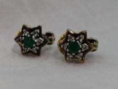 A pair of yellow metal stud earrings stamped 18 having clip style butterfly back, with emerald style