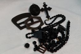 A small selection of black mourning style jewellery including carved vulcanite locket having