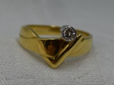 A lady's dress ring of stylised band form having a diamond solitaire approx 0.128ct in a collared