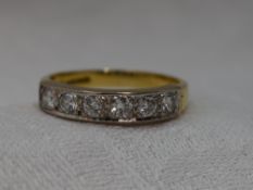 A lady's half eternity ring having six diamonds, total approx 0.38ct in pave mounted channel setting