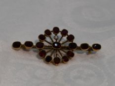 A garnet and seed pearl bar brooch in yellow metal mount stamped 9ct (af)