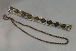 A white metal articulated band bracelet stamped 925 having brushed finish with gold plated