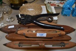 A collection of vintage wooden shuttles, a Lloyd Loom repair kit and a leather punch or similar.